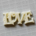 Пластикове прикраса "Love" кольору слонової кістки, 23х10 мм