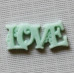 Пластикове прикраса "Love" ментолової кольору, 23х10 мм